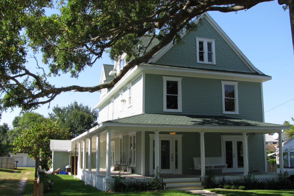 Image of historic colonial three story train station master's home in Dunedin Florida